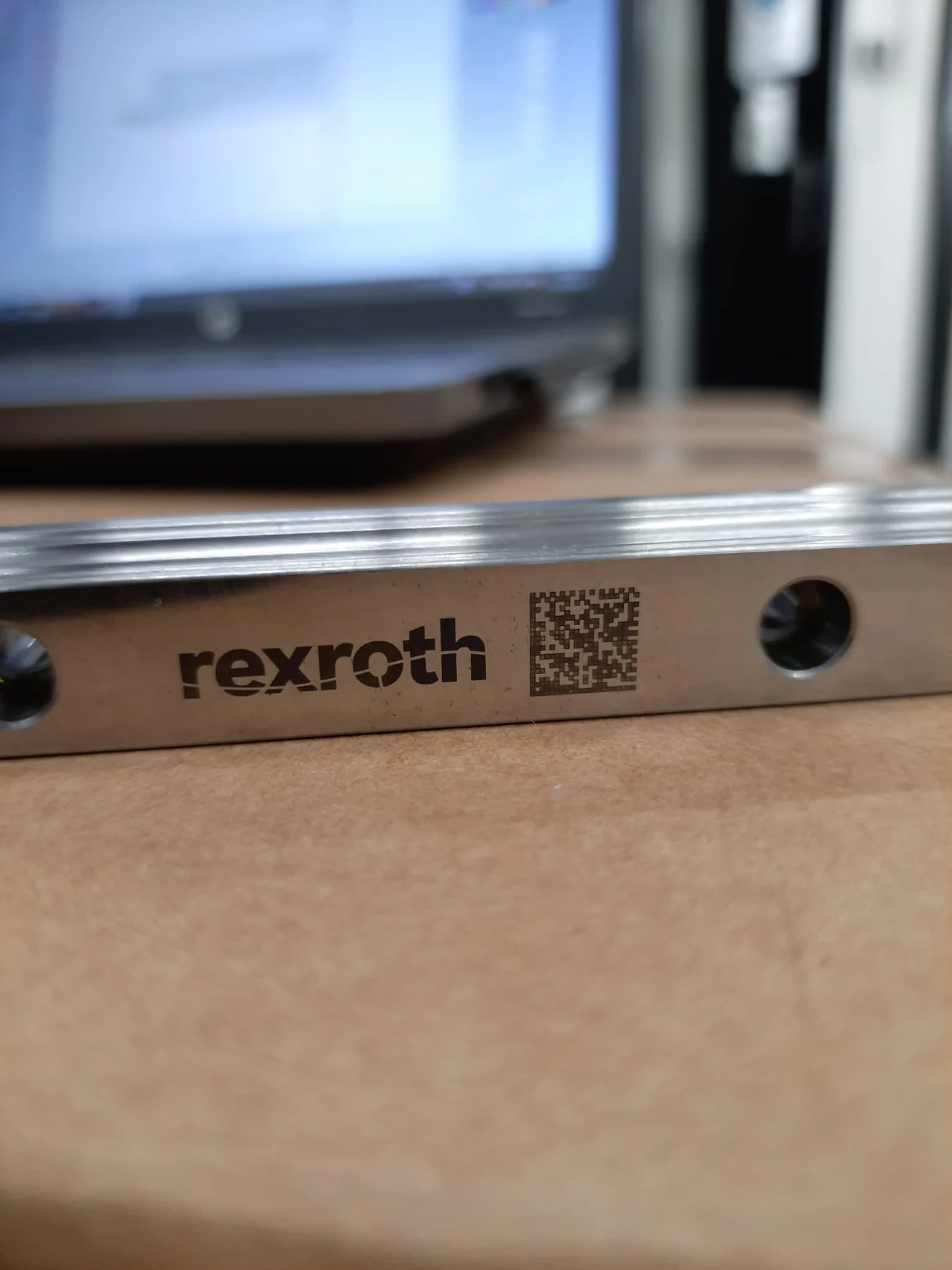 Laser marked logo and Data Matrix code on a metal plate